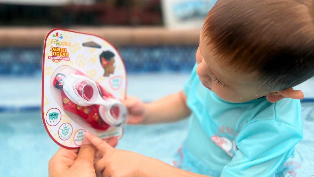 Child looking at Frogglez Goggles Daniel Tiger's Neighborhood swim goggles for kids 3-10. best swim gear for kids