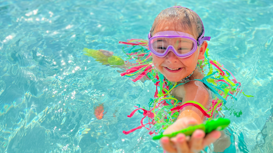 wearing frogglez goggles purple half mask in pool. Frogglez comfortable swim goggles for girls swimming in swimming pools. Best swim goggles. 