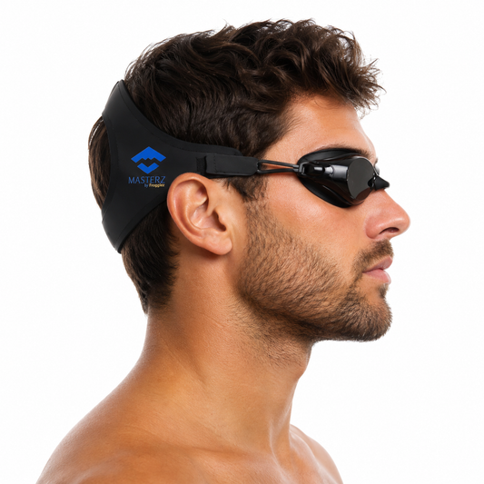 A man in profile wearing black Masterz swim goggles with a black headband featuring a blue logo, against a solid white background.