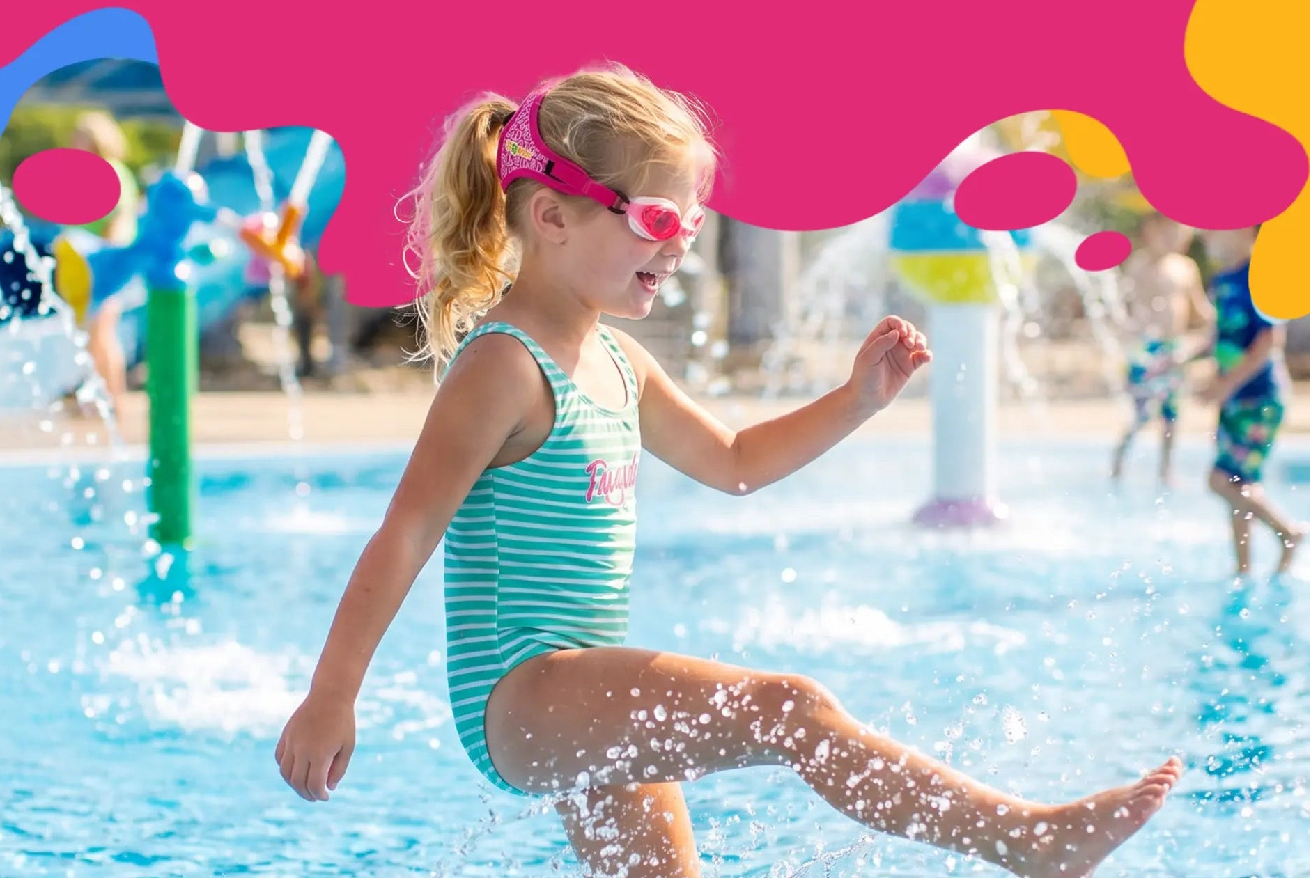 Child playing in water at a waterpark with 'Frogglez' branding.